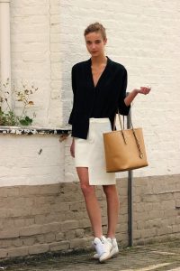 black blouse, cream high low skirt with metallic sneakers