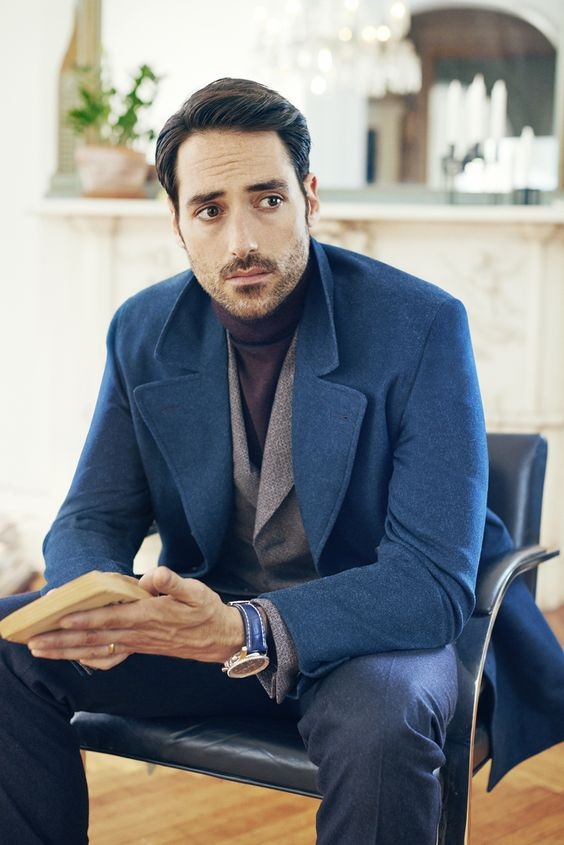 Men's holiday style, what to wear to casual holiday party, men's blue overcoat, black turtleneck, gray blazer and jeans